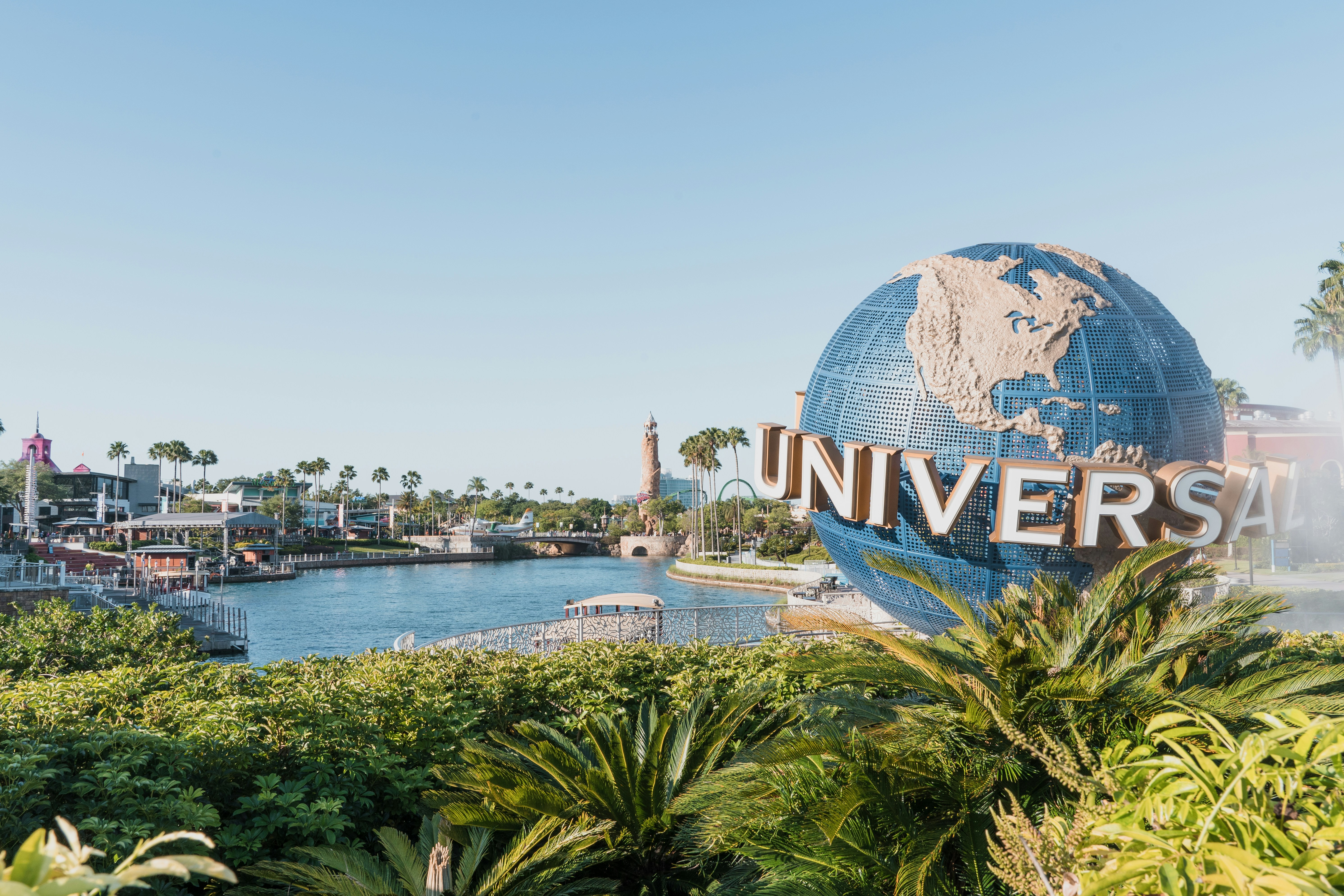 Universal Studios Orlando globe surrounded by tropical landscaping and waterfront attractions